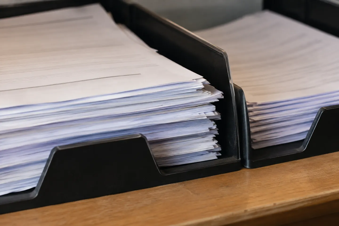 Close-up of two overlapping paper enquiry slips separated into original and follow-up trays